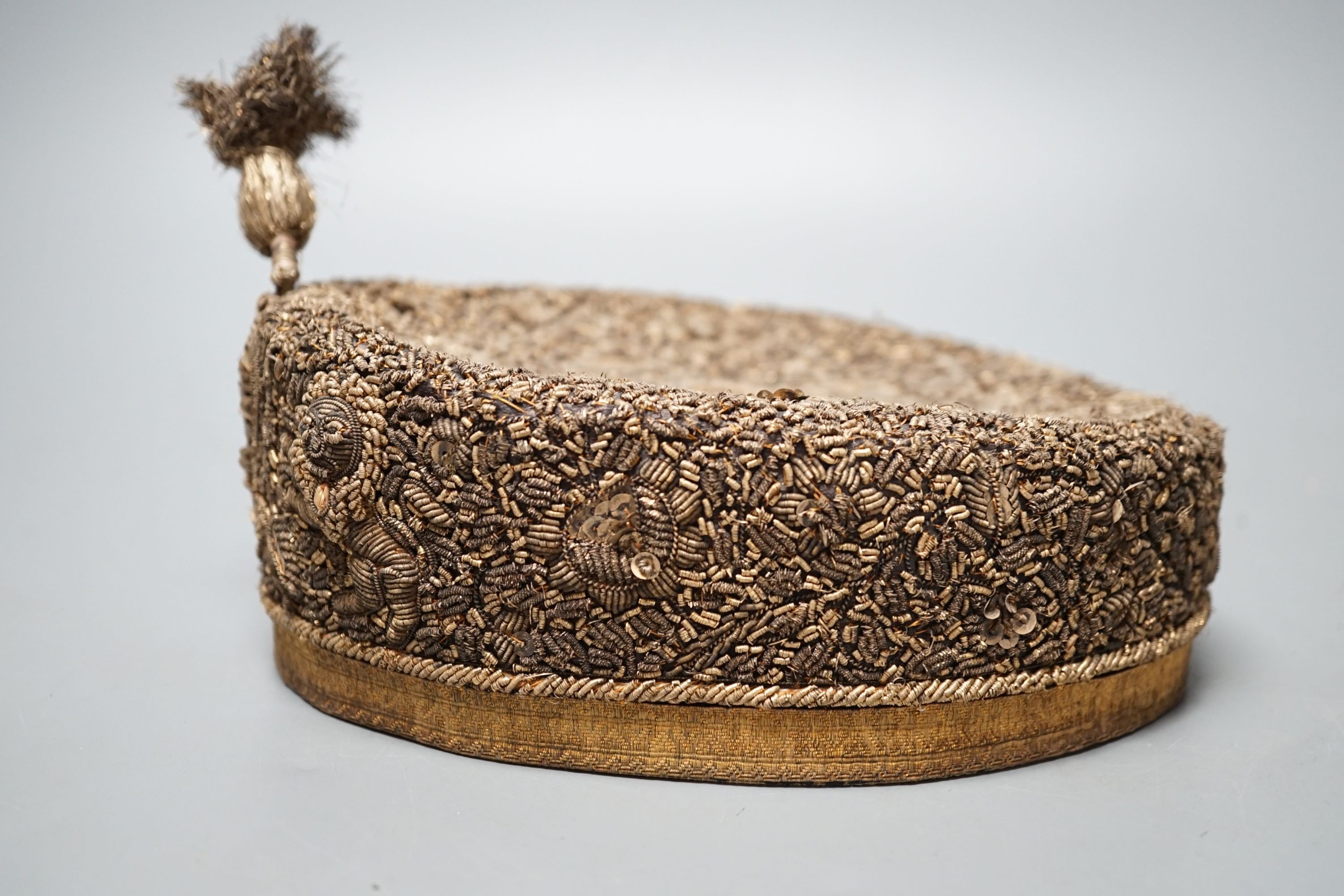 An Indian heavily embroidered cap with sequins and gilt thread 18cm